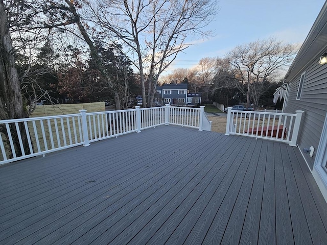 wooden terrace featuring a lawn