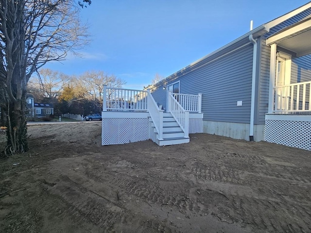 view of property exterior with a wooden deck