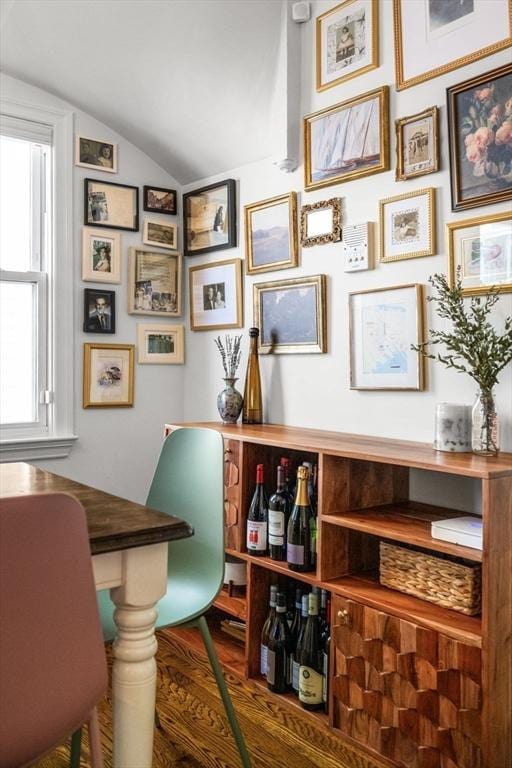 home office featuring vaulted ceiling and wood finished floors