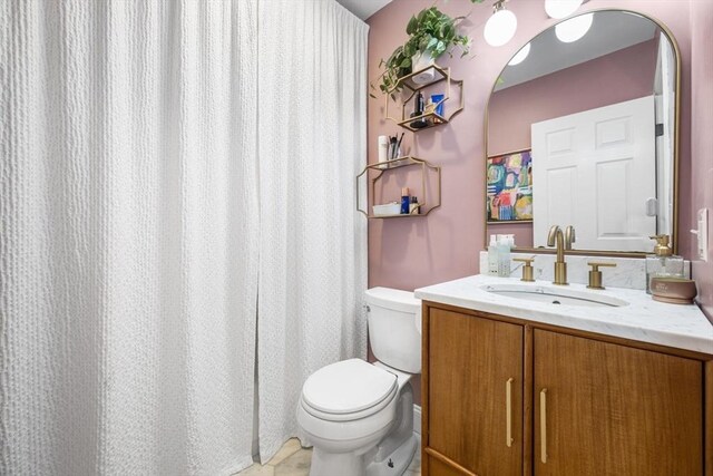 full bathroom featuring toilet and vanity