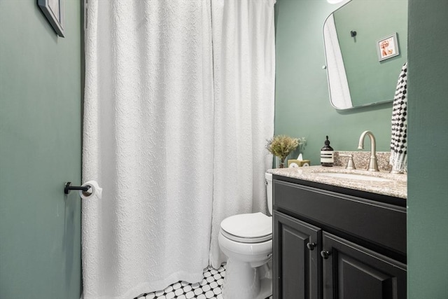 full bath featuring toilet and vanity