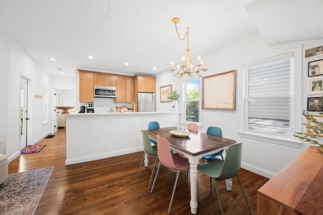 dining space with a chandelier, wood finished floors, recessed lighting, and baseboards