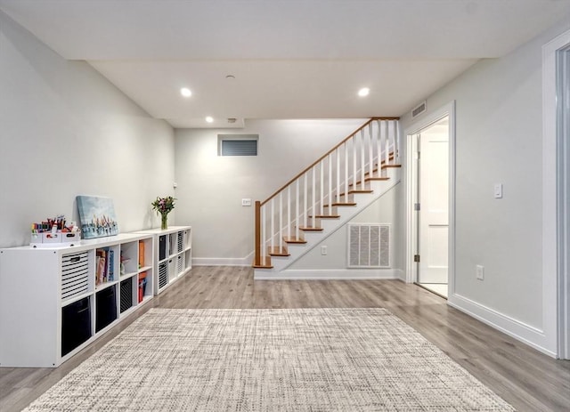 36 Hall Unit 1, Boston, MA 02130 - below grade area featuring wood finished floors, stairs, baseboards, and recessed lighting