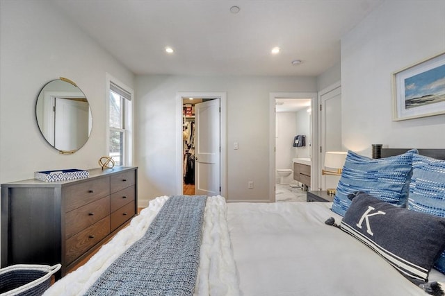 36 Hall Unit 1, Boston, MA 02130 - bedroom featuring baseboards, a walk in closet, recessed lighting, connected bathroom, and marble look tiles