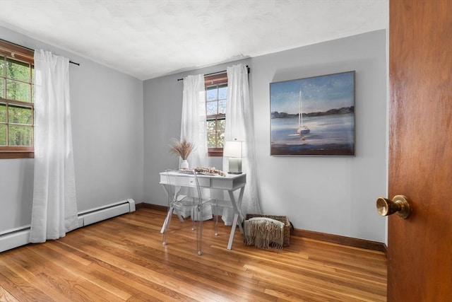 home office featuring wood finished floors and baseboards