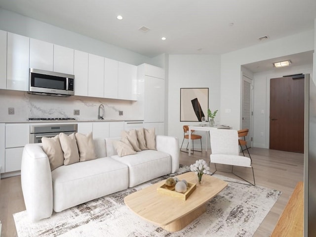 135 Seaport Blvd Unit 526, Boston, MA 02210 - living room featuring light wood-style flooring and recessed lighting