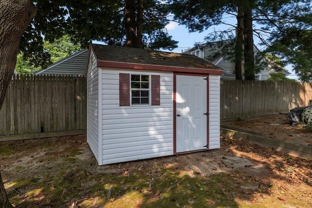 view of shed with a fenced backyard