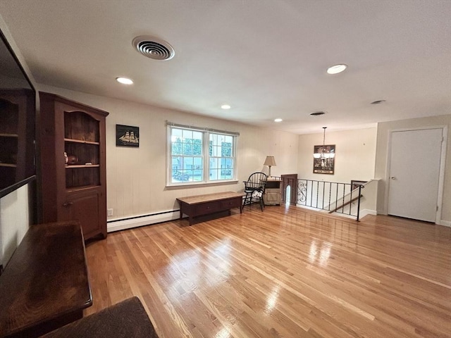 interior space with visible vents, a baseboard heating unit, wood finished floors, recessed lighting, and a chandelier