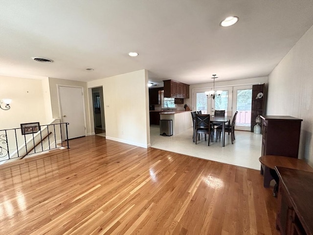 dining space with visible vents, a notable chandelier, recessed lighting, light wood-style floors, and baseboards