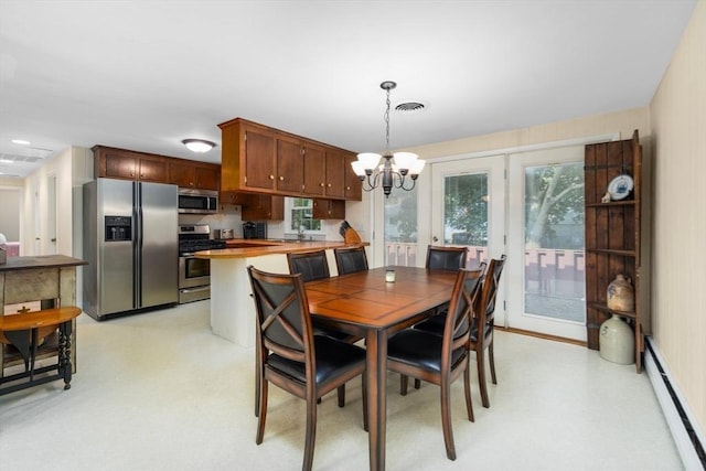 dining space featuring a notable chandelier, visible vents, light floors, and a baseboard heating unit