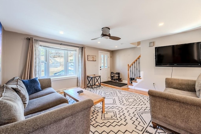 living room with stairs, recessed lighting, wood finished floors, and baseboards