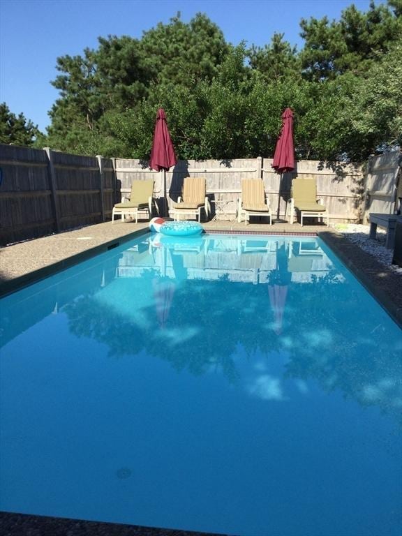 view of swimming pool with a fenced backyard and a fenced in pool