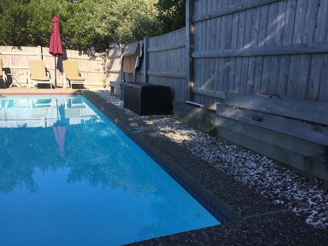 view of swimming pool featuring a fenced in pool and a fenced backyard