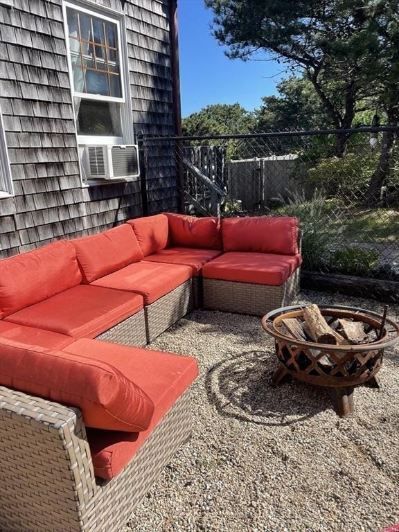 view of patio with cooling unit, fence, and an outdoor living space