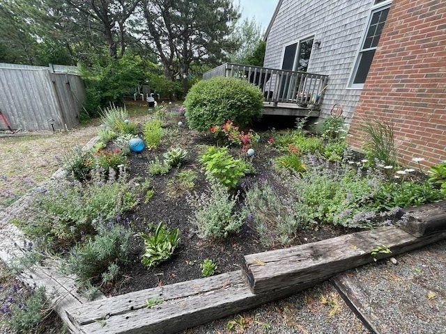 view of yard featuring fence and a wooden deck