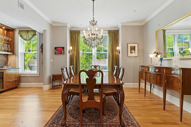 2 Cumston St Unit 2, Boston, MA 02118 - dining room featuring light wood-style flooring, a chandelier, baseboards, and crown molding