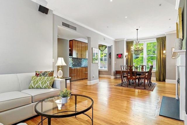 2 Cumston St Unit 2, Boston, MA 02118 - living room with light wood-type flooring, crown molding, a chandelier, and baseboards