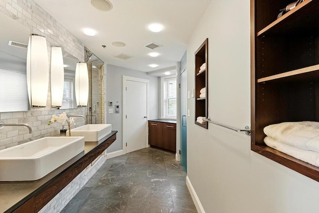 2 Cumston St Unit 2, Boston, MA 02118 - bathroom with baseboards, double vanity, and decorative backsplash
