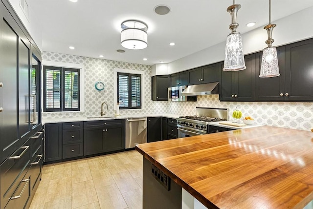 2 Cumston St Unit 2, Boston, MA 02118 - kitchen featuring appliances with stainless steel finishes, wood counters, under cabinet range hood, a sink, and decorative backsplash