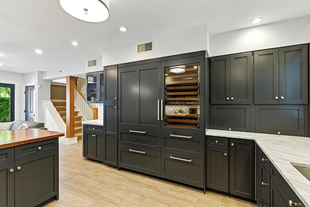 2 Cumston St Unit 2, Boston, MA 02118 - kitchen with light stone counters, glass insert cabinets, and recessed lighting