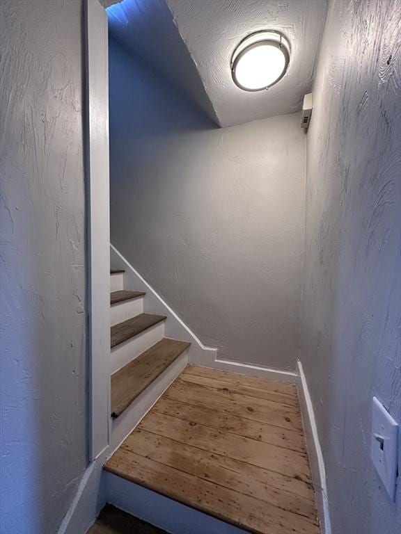 stairs featuring wood-type flooring