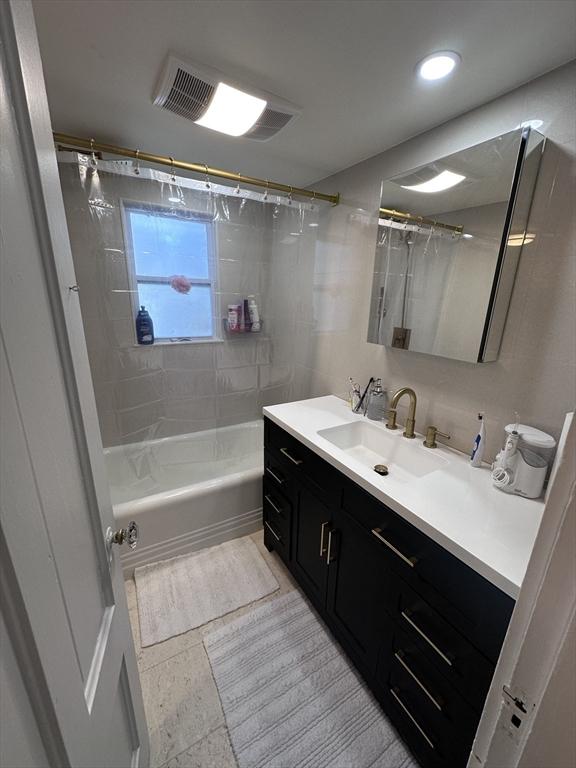 bathroom featuring tile patterned floors, shower / tub combo with curtain, and vanity