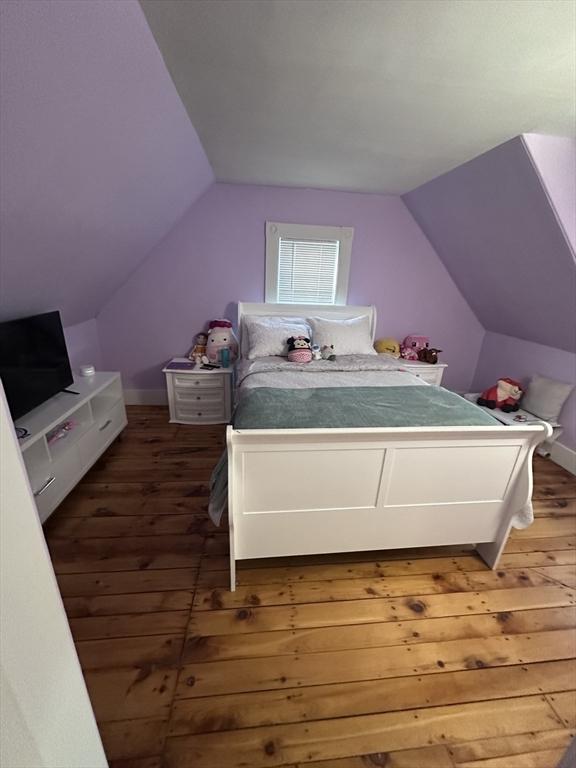 bedroom with lofted ceiling and dark wood-type flooring