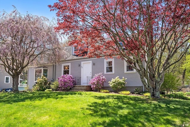 new england style home with a front yard