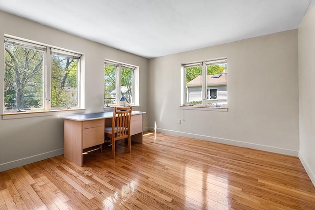 home office featuring plenty of natural light and light wood-style flooring