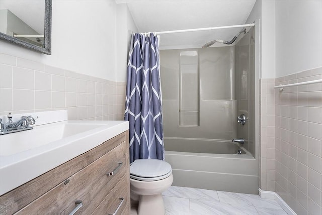 full bathroom with tile walls, vanity, toilet, marble finish floor, and shower / bathtub combination with curtain