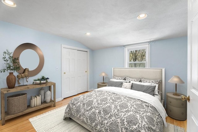 bedroom featuring recessed lighting, wood finished floors, and vaulted ceiling