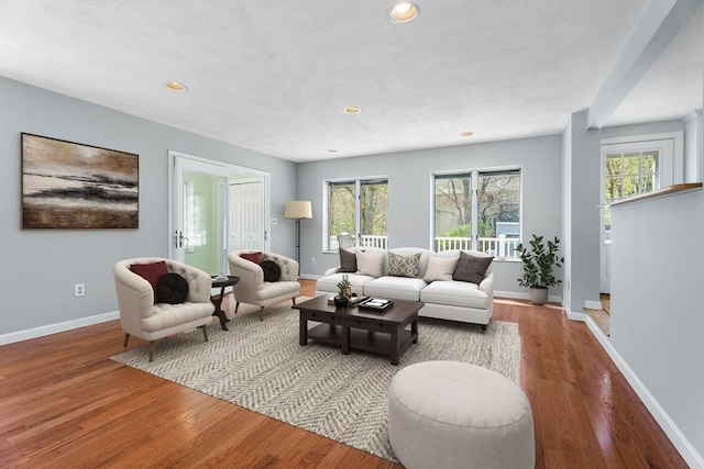 living area featuring baseboards, recessed lighting, and wood finished floors
