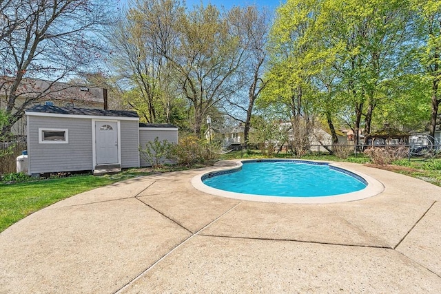 view of pool featuring fence, a patio, a storage shed, a fenced in pool, and an outdoor structure