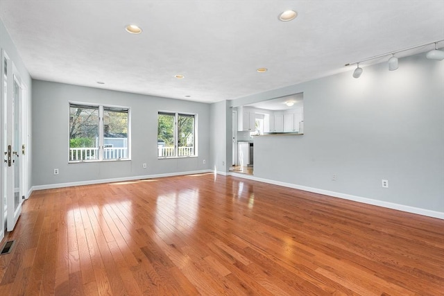 unfurnished living room featuring recessed lighting, baseboards, visible vents, and light wood finished floors