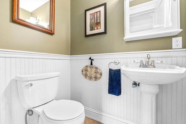 bathroom with sink, toilet, and tile patterned flooring