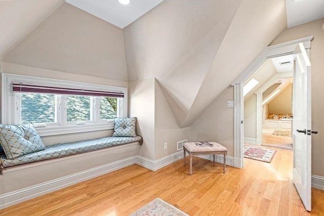 additional living space featuring light hardwood / wood-style flooring and lofted ceiling