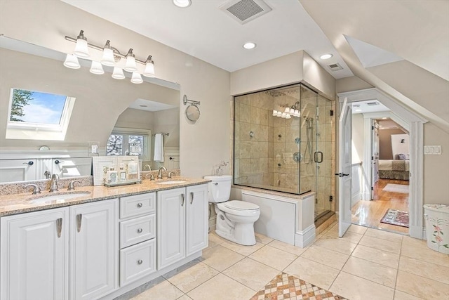 bathroom featuring vanity, tile patterned floors, a skylight, and an enclosed shower