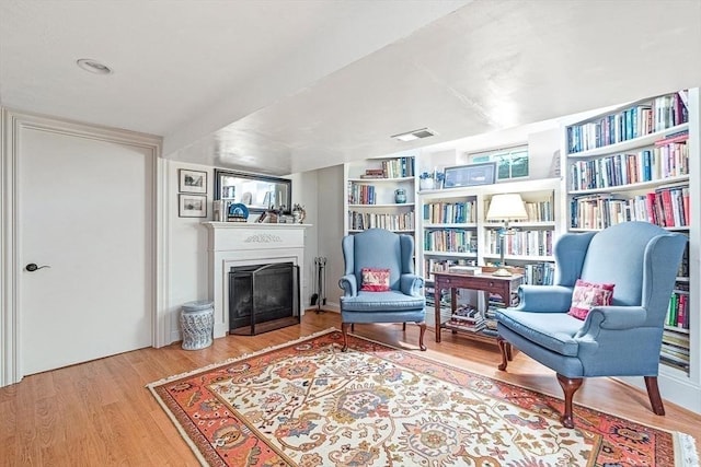 living area with hardwood / wood-style flooring