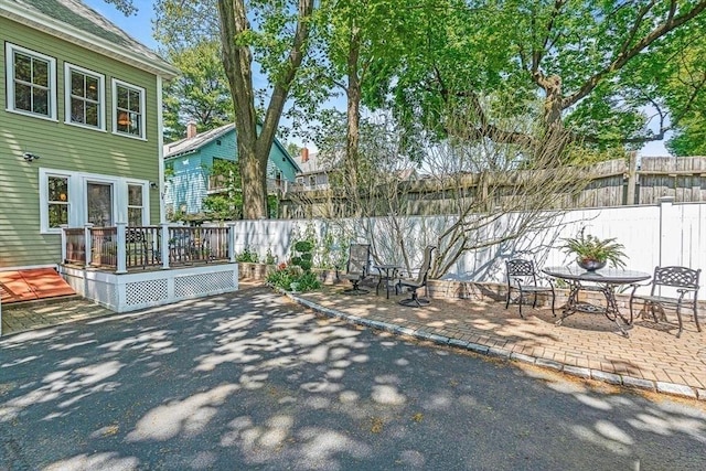 view of yard featuring a patio area and a wooden deck