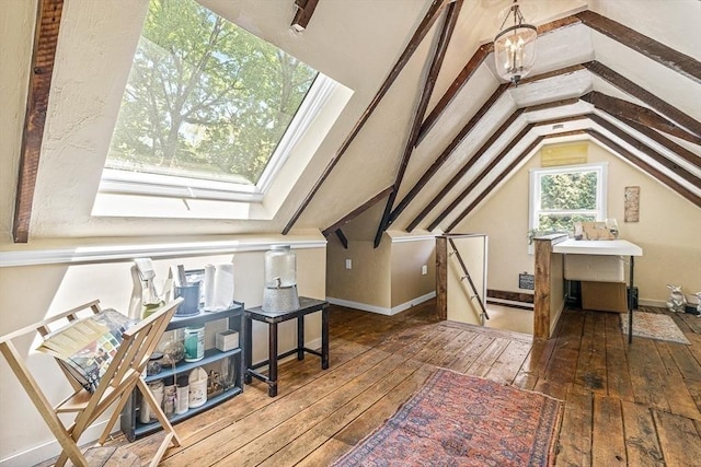 additional living space with a chandelier, dark hardwood / wood-style floors, and vaulted ceiling with skylight