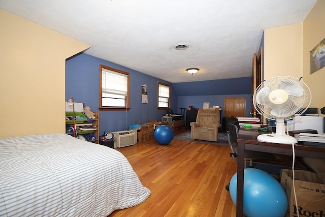 bedroom with visible vents and light wood-style flooring