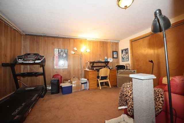 carpeted office space featuring wooden walls