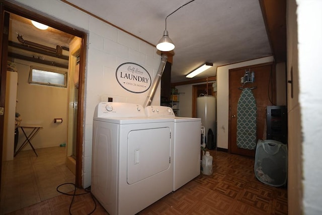 laundry area with independent washer and dryer, concrete block wall, water heater, and laundry area
