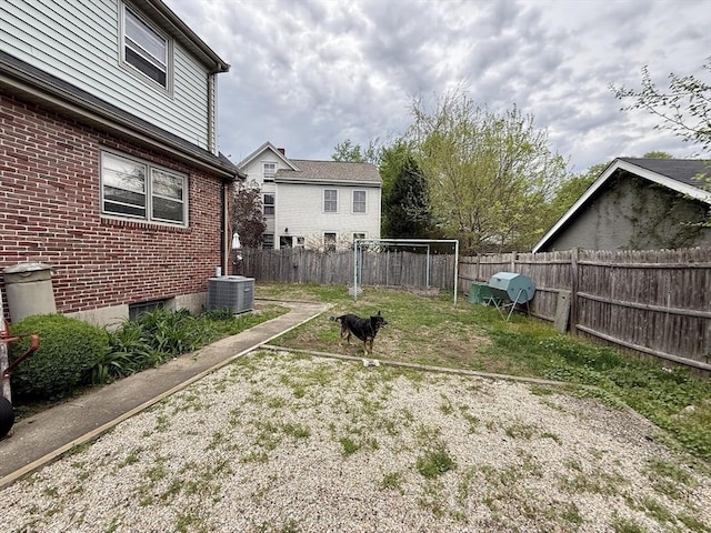 view of yard featuring central AC unit and a fenced backyard
