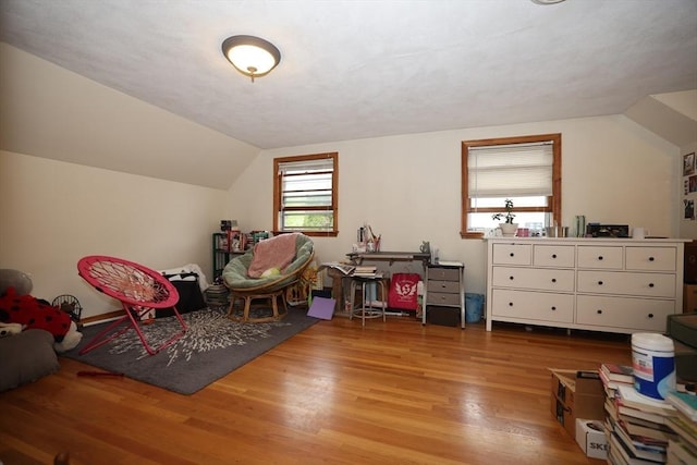 rec room with vaulted ceiling and wood finished floors