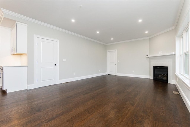 unfurnished living room featuring dark hardwood / wood-style flooring and ornamental molding