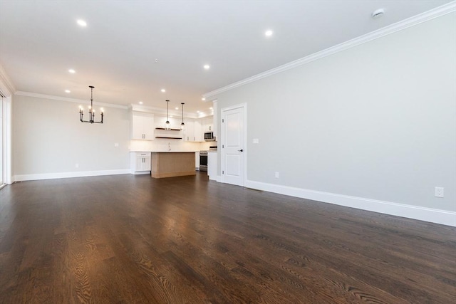 unfurnished living room with a notable chandelier, dark hardwood / wood-style flooring, and crown molding