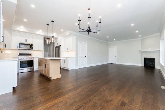 kitchen featuring pendant lighting, dark hardwood / wood-style floors, appliances with stainless steel finishes, a kitchen island, and white cabinetry