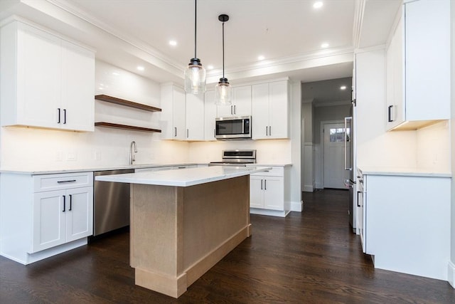 kitchen featuring white cabinetry, pendant lighting, dark wood-type flooring, and appliances with stainless steel finishes