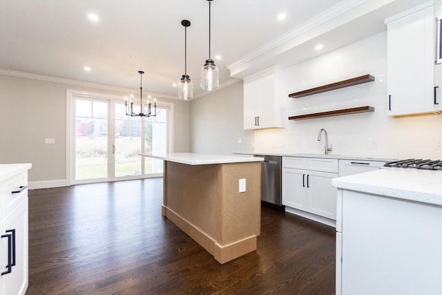 kitchen with stainless steel dishwasher, ornamental molding, dark wood-type flooring, sink, and white cabinetry